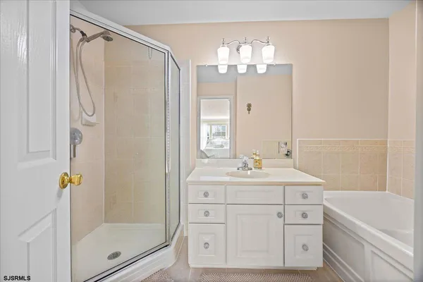a bathroom with a sink toilet tub and shower