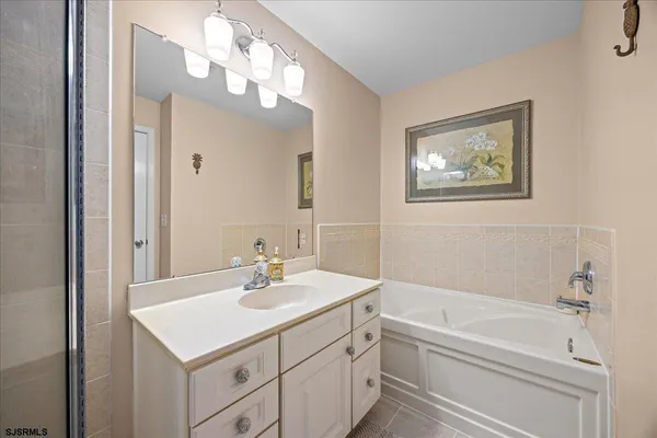 a front view of a house with a tree