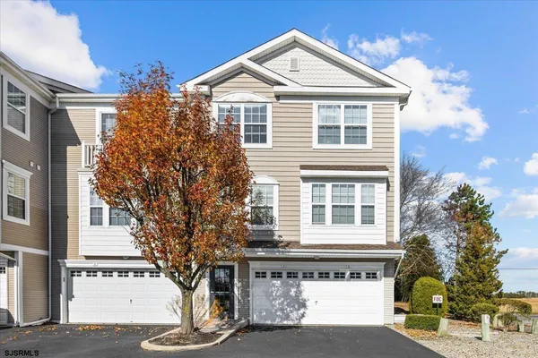 a kitchen with white cabinets sink and white appliances