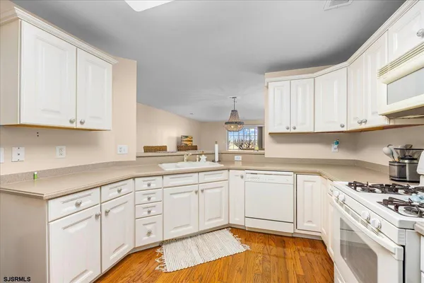 a kitchen with a refrigerator sink stove and cabinets