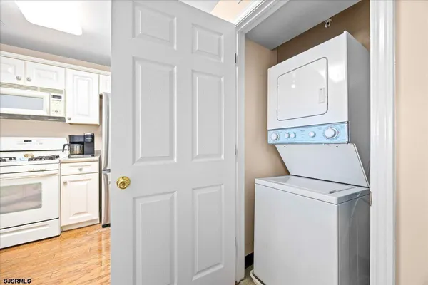 a kitchen with granite countertop a refrigerator oven a sink and dishwasher