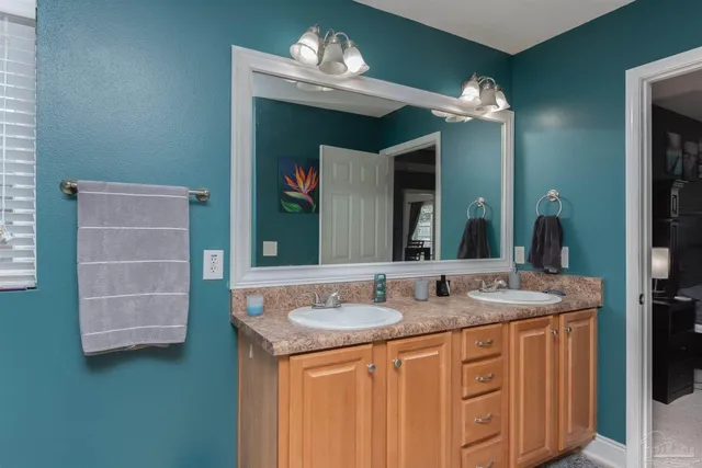 a bathroom with a double vanity sink and a mirror