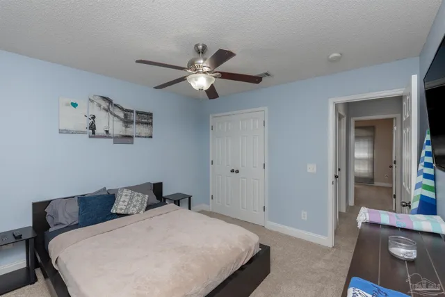a bathroom with a granite countertop sink toilet and a mirror
