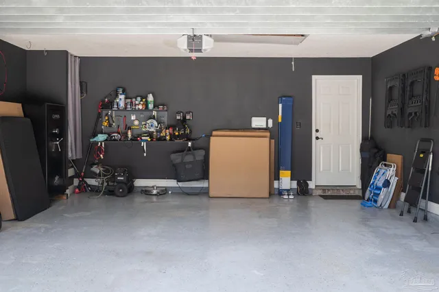 a view of backyard with small cabin and wooden fencing