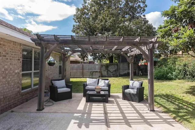 a view of a house with backyard and a tree