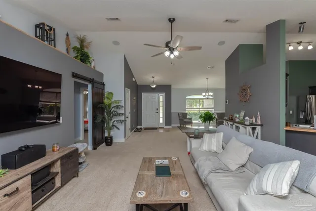 a living room with furniture and a flat screen tv