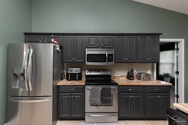 a kitchen with stainless steel appliances a refrigerator stove and sink