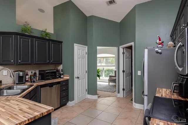 a kitchen that has a sink and a stove in it