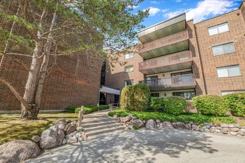 a pathway of a house with a yard