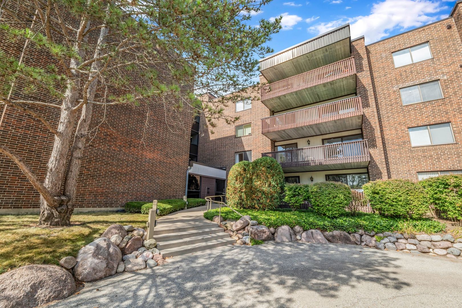 a pathway of a house with a yard
