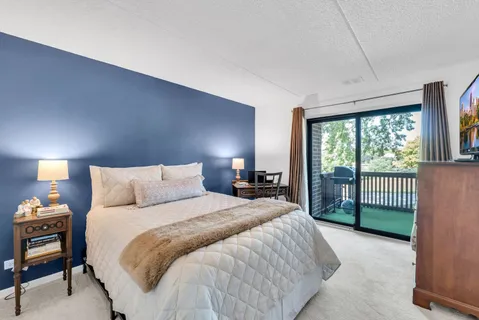 a bathroom with a sink a toilet a mirror and shower