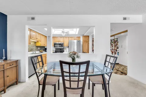 a kitchen with stainless steel appliances granite countertop a refrigerator a stove and a sink with cabinets