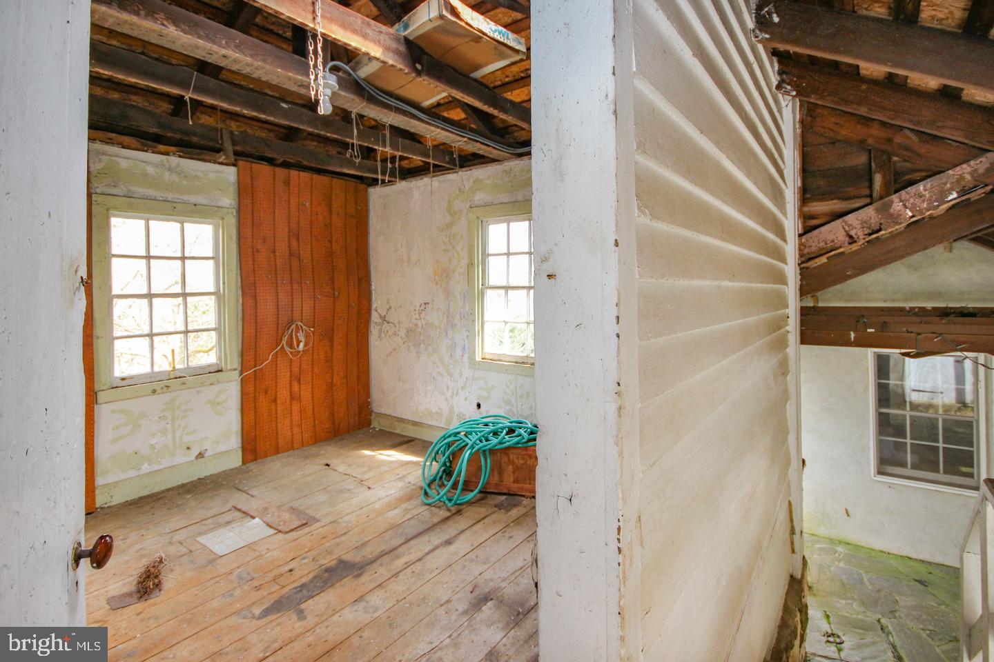 432 Old Forge Road Media, PA 19063 - Photo 35 of 41 a view of a hallway with wooden floor and windows