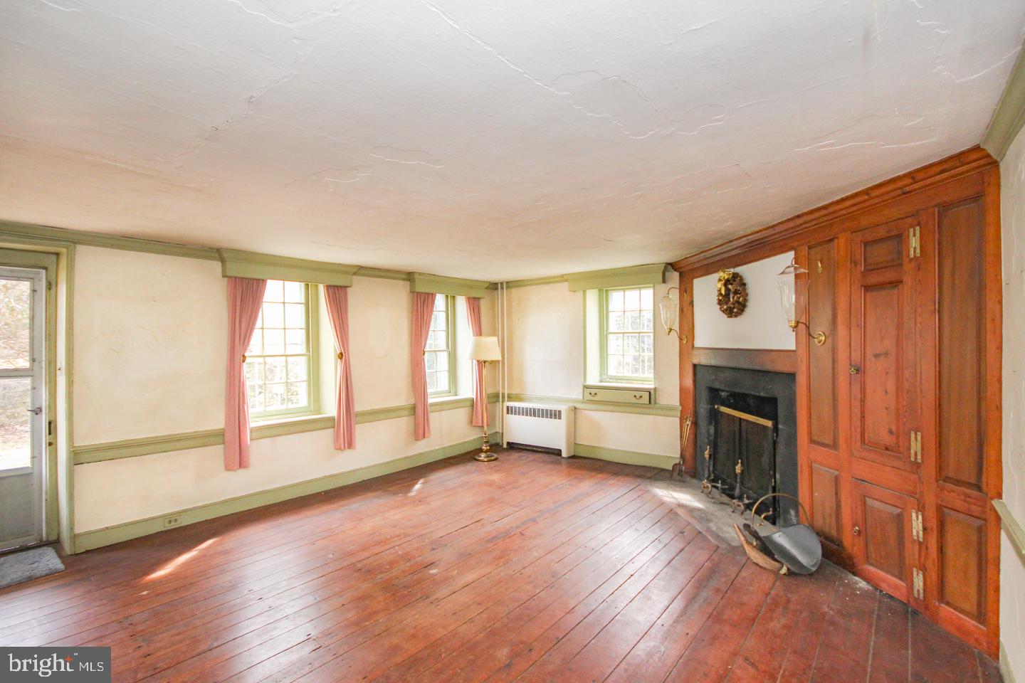 432 Old Forge Road Media, PA 19063 - Photo 5 of 41 an empty room with fireplace wooden floor and windows