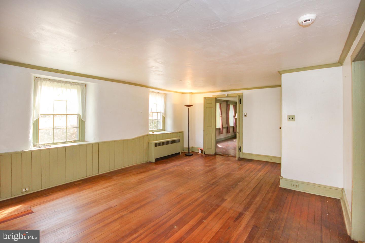 432 Old Forge Road Media, PA 19063 - Photo 6 of 41 an empty room with wooden floor and windows