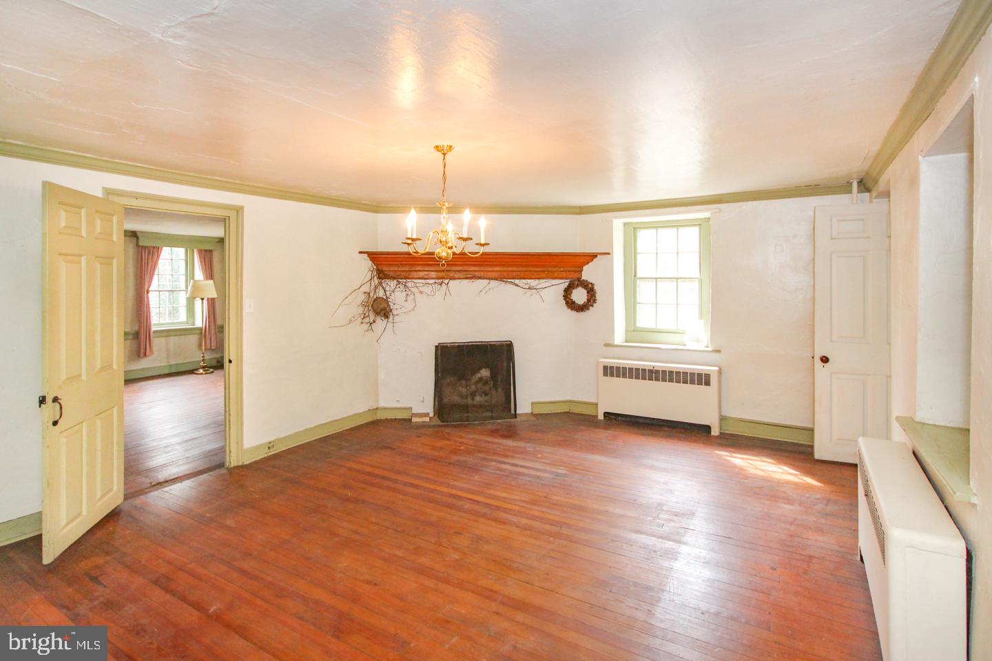432 Old Forge Road Media, PA 19063 - Photo 8 of 41 an empty room with wooden floor fireplace and windows