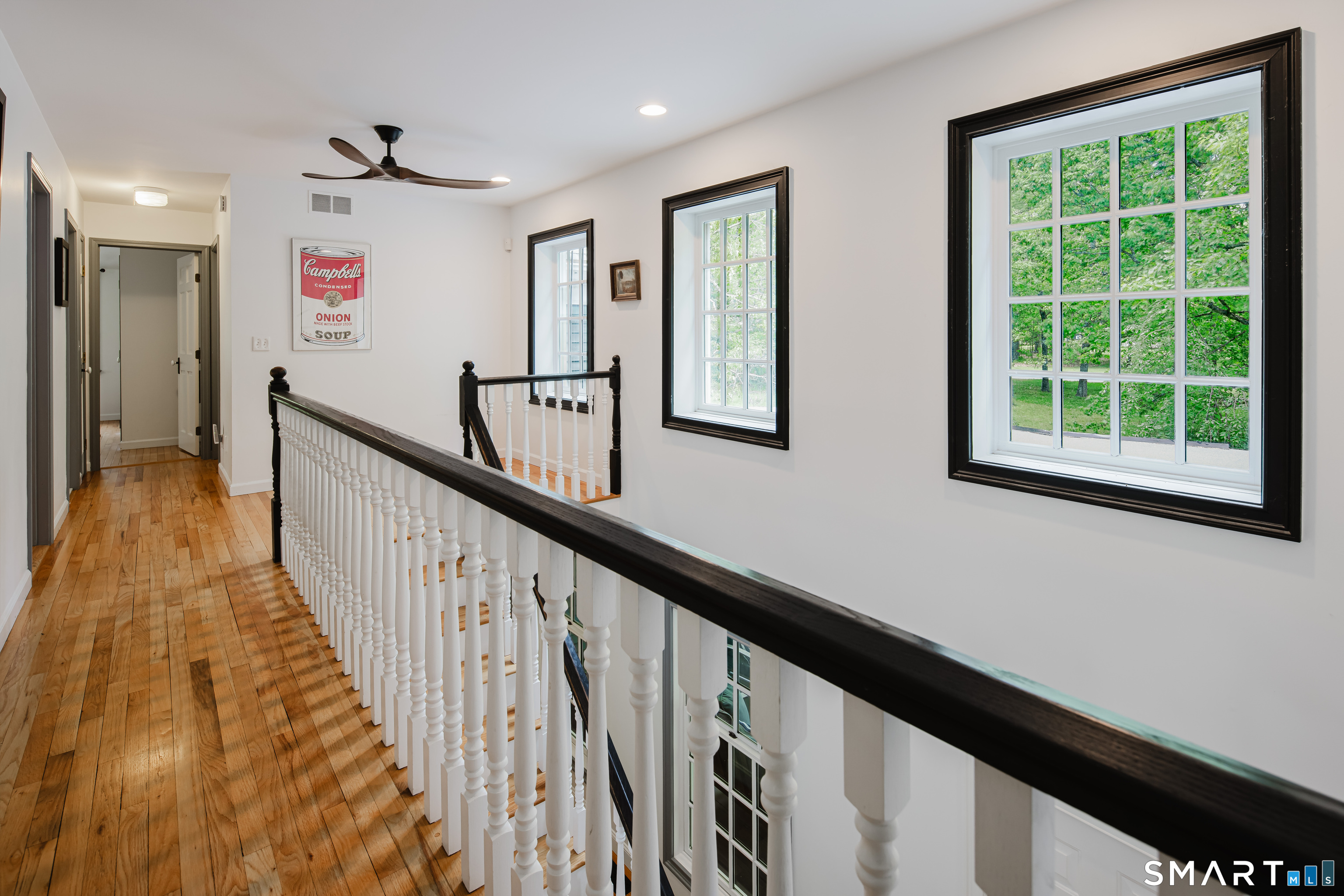 3 Partridge Trail Sherman, CT 06784 - Photo 25 of 37 a view of a hallway with wooden floor and windows