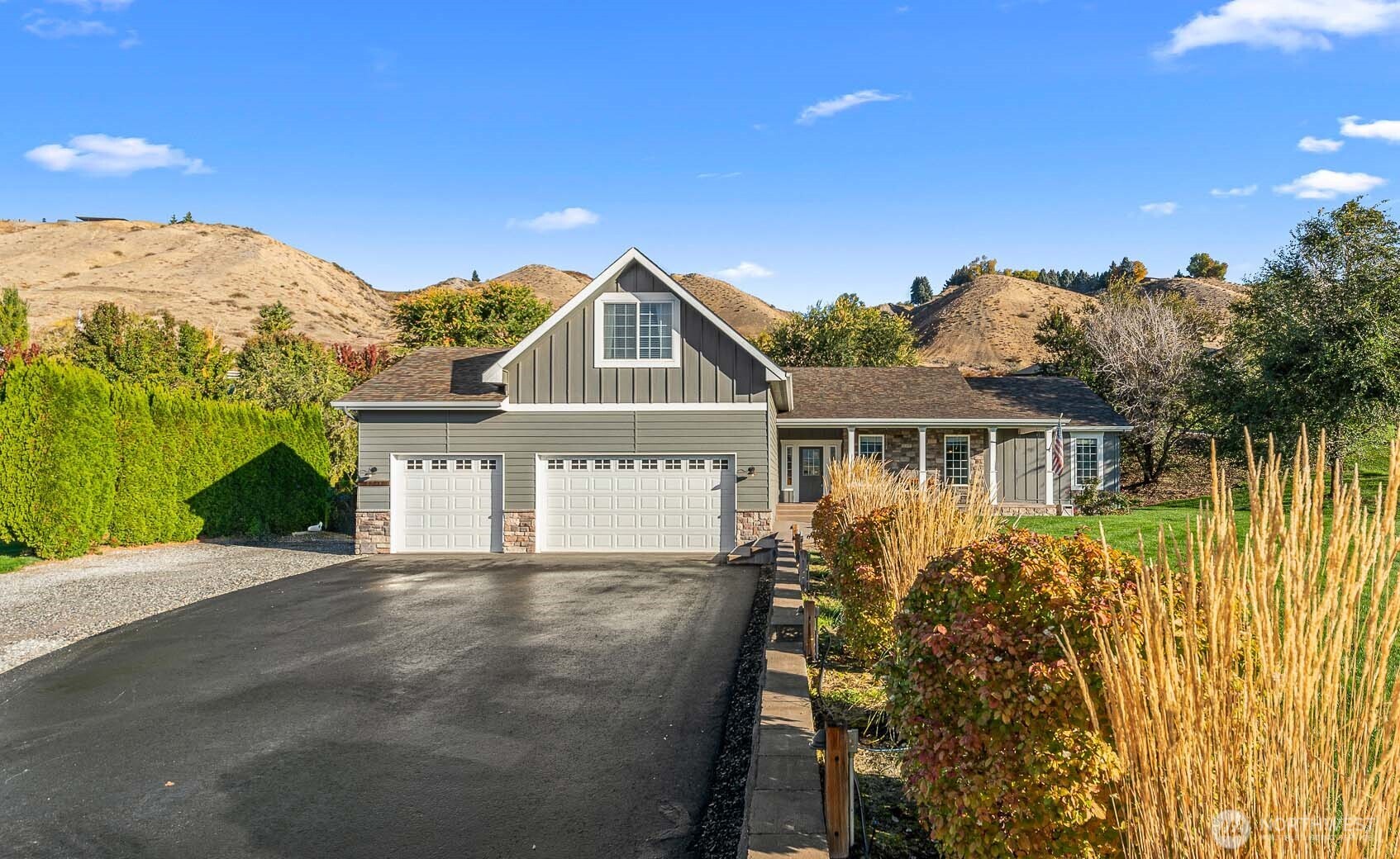 2945 Martin Place East Wenatchee, WA 98802 - Photo 1 of 40 a front view of a house with a yard and potted plants