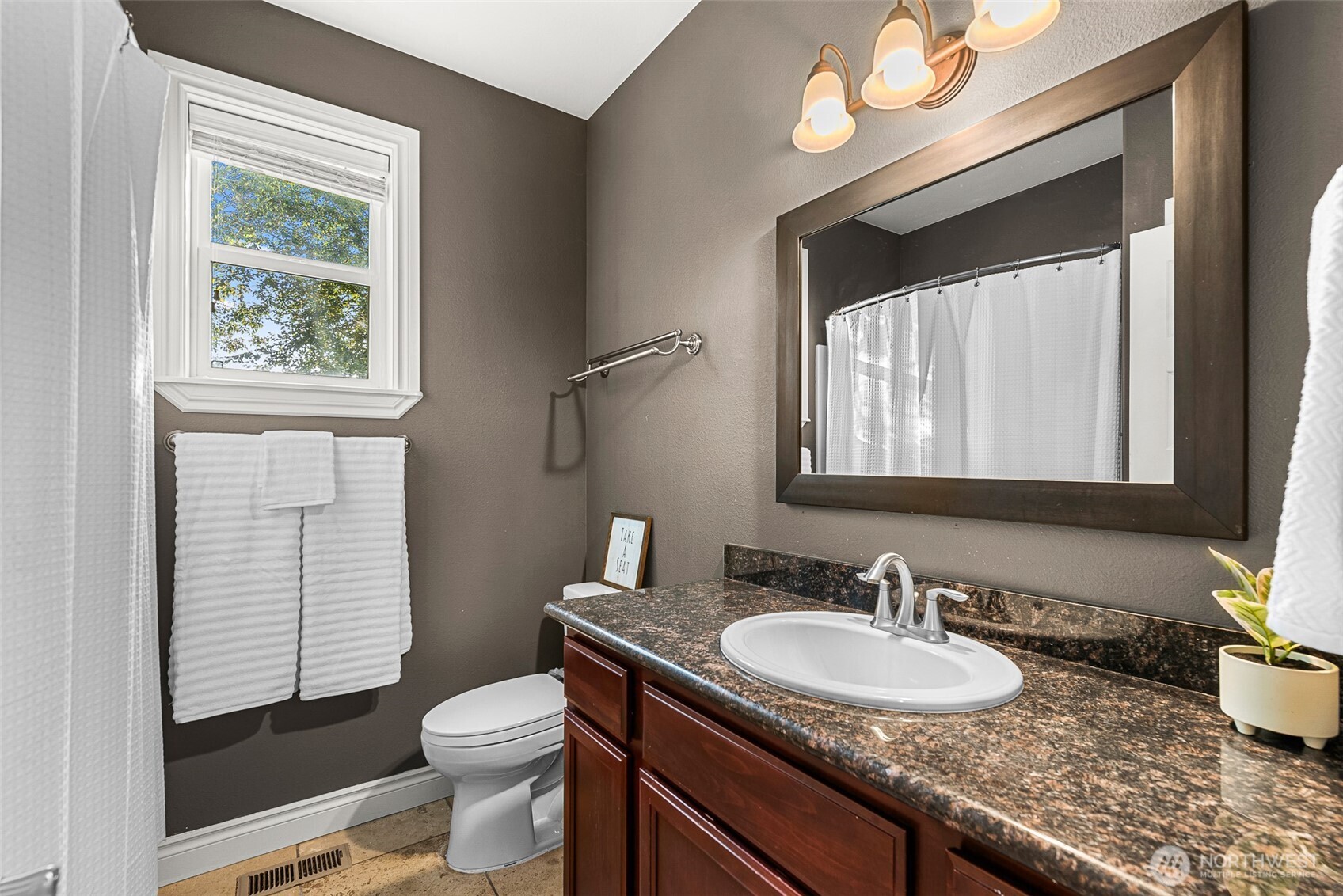 2945 Martin Place East Wenatchee, WA 98802 - Photo 24 of 40 a bathroom with a granite countertop sink vanity mirror and toilet