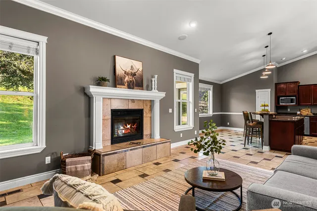 a living room with furniture a fireplace and a table