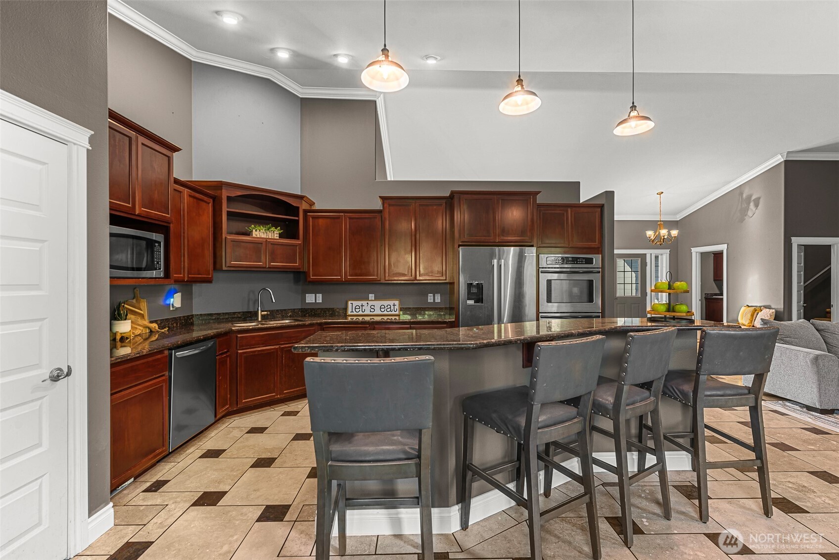 2945 Martin Place East Wenatchee, WA 98802 - Photo 9 of 40 a kitchen with stainless steel appliances granite countertop a stove top oven a sink a dining table and chairs