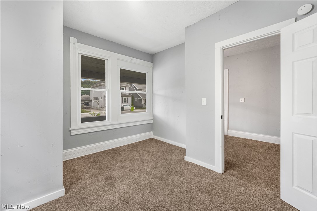 885 Wales Road Northeast Massillon, OH 44646 - Photo 28 of 34 Carpeted interior space featuring light gray walls and white trim
