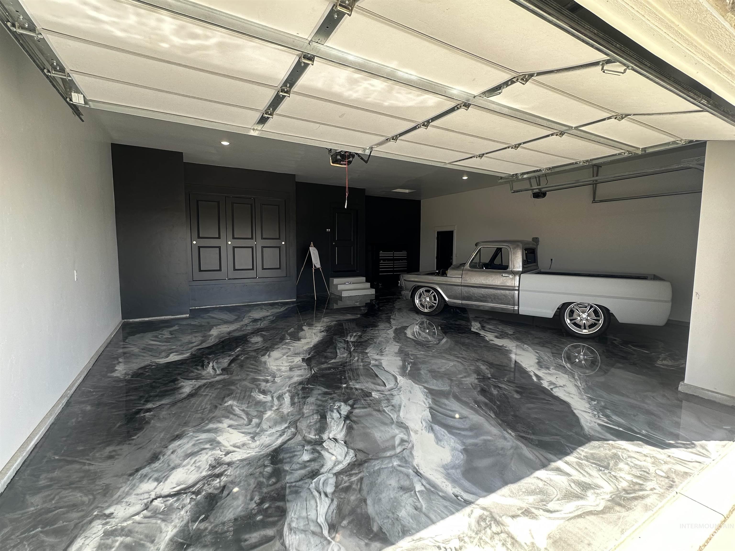 3035 Lake View Twin Falls, ID 83301 - Photo 40 of 41 Spacious garage featuring a marbled epoxy floor, automatic overhead door, recessed lighting, built-in wall cabinetry, and a dedicated entry door