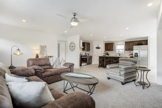 a living room with furniture and kitchen view