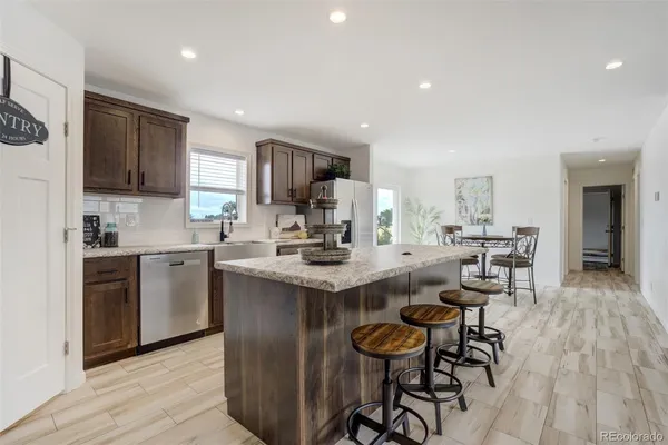 a kitchen with a sink cabinets and wooden floor