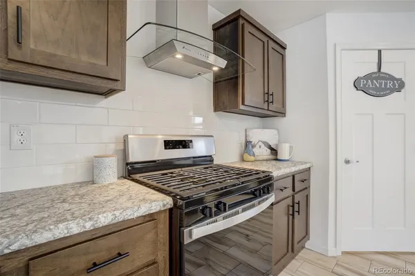 a kitchen with stainless steel appliances granite countertop a stove and a microwave