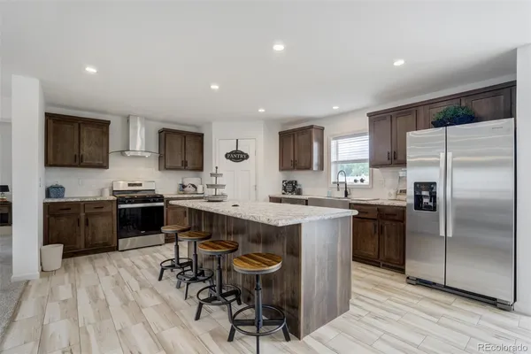 a kitchen with a sink stainless steel appliances and cabinets