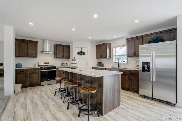 a kitchen with a sink stainless steel appliances and cabinets