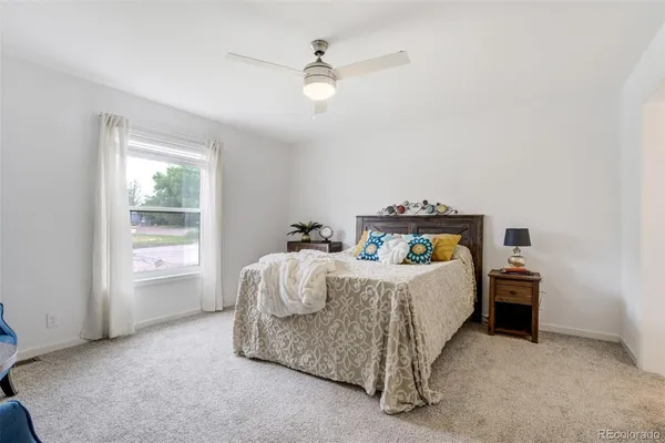 a bed sitting in a bedroom next to a window