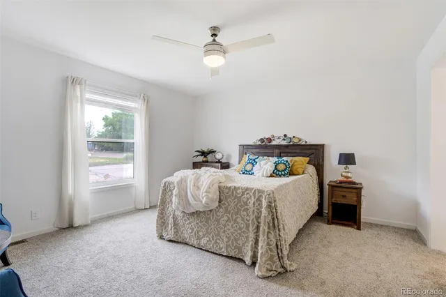 a bed sitting in a bedroom next to a window