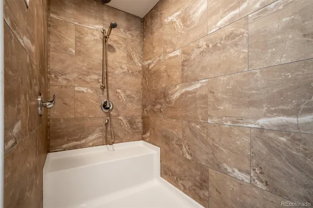 a bathroom with a white bath tub and a shower