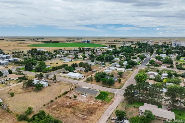 a front view of a building with a garden