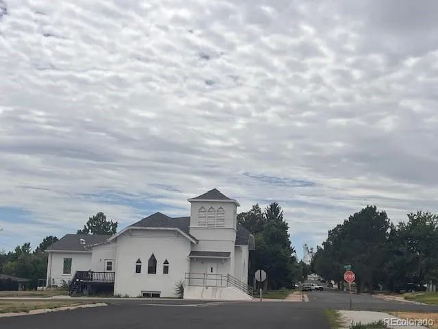 a view of a house with a snow in the background