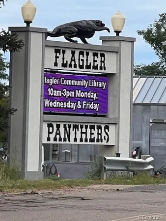 a front view of a building with a sign board