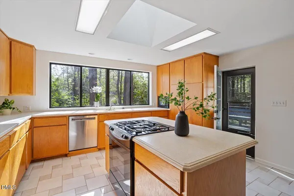 a kitchen that has a sink and a wooden floor