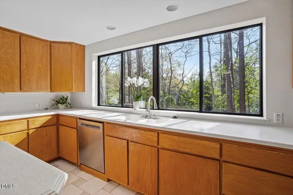 a kitchen with a sink and large window