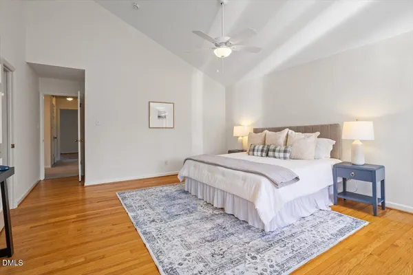 a bedroom with a large bed and a chandelier