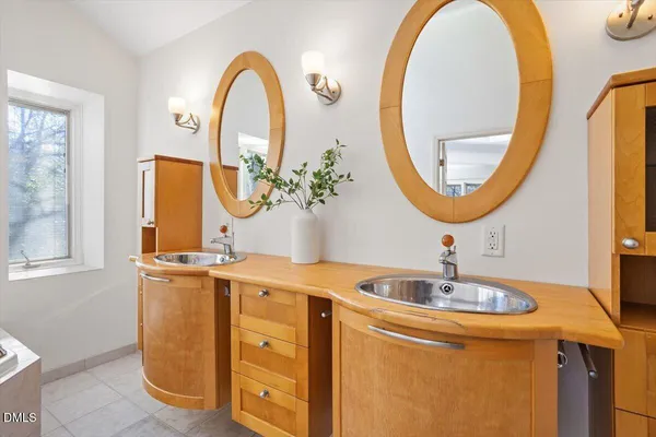 a bathroom with a double vanity sink and a mirror