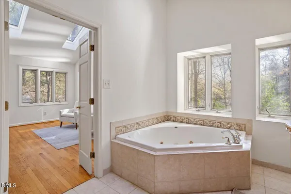 a bathroom with bathtub and window