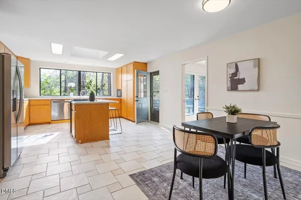 a view of a dining room with furniture and a kitchen
