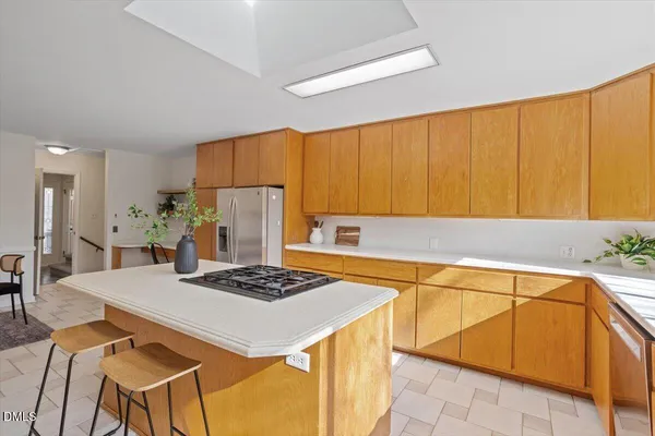 a kitchen with a sink cabinets and wooden floor