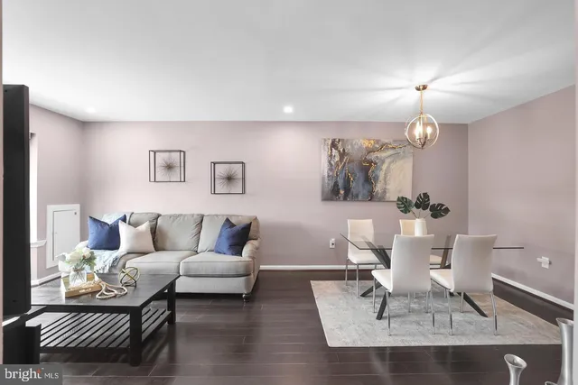 a living room with furniture a rug and a chandelier