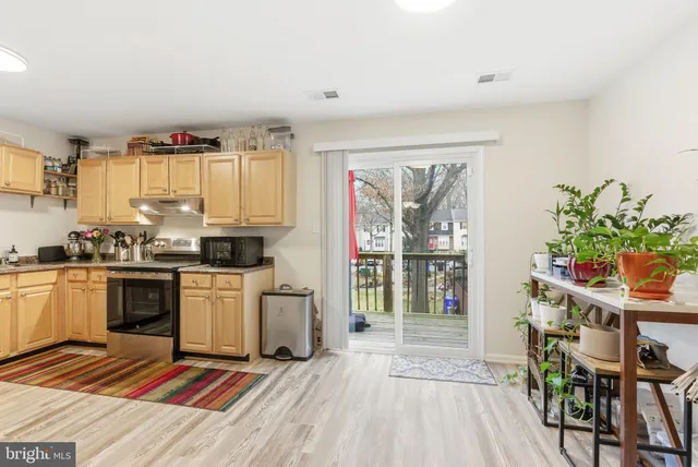 a open kitchen with granite countertop a stove a sink dishwasher and a refrigerator