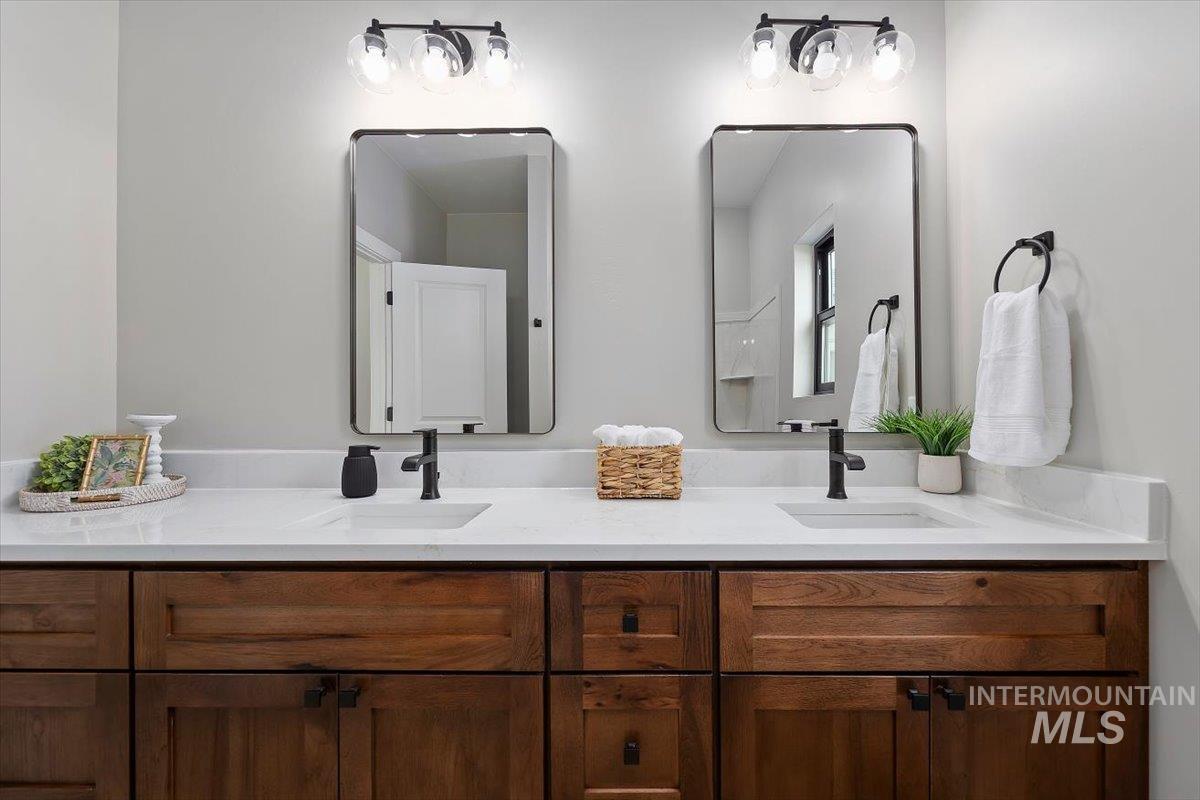 1201 Jade Drive Rupert, ID 83350 - Photo 18 of 27 Dual vanity with recessed sinks, matte black faucets, and rectangular framed mirrors