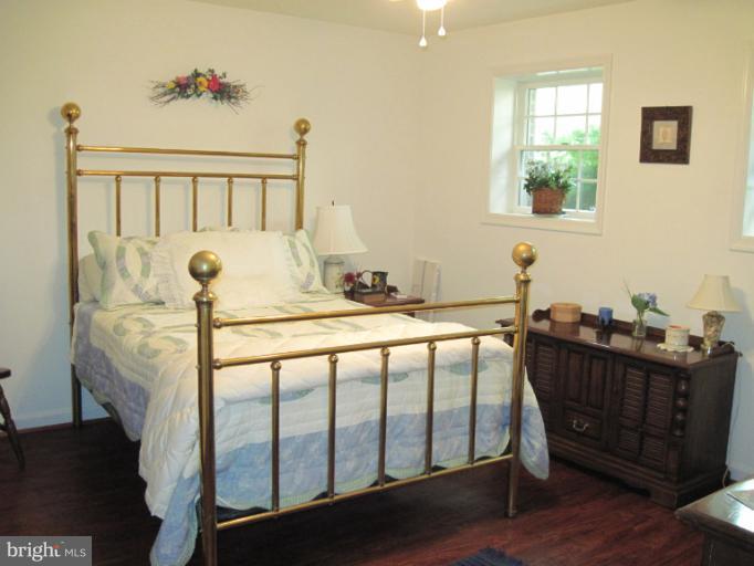 9269 Mountjoy Road Marshall, VA 20115 - Photo 3 of 14 a bedroom with a bed and wooden floor