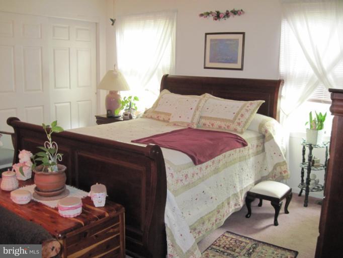 9269 Mountjoy Road Marshall, VA 20115 - Photo 8 of 14 a bed room with a bed chair and a lamp